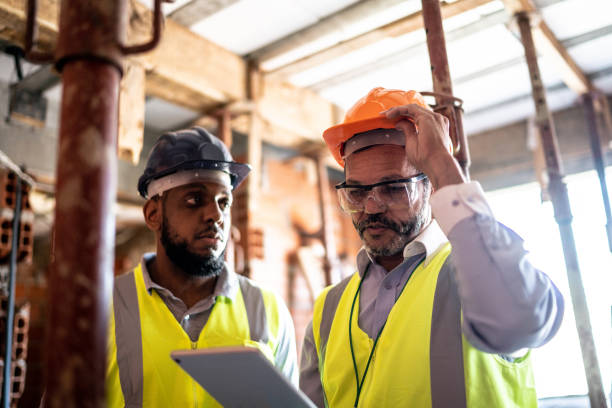 istock Engineer and contractor doing an informal meeting on construction site 1334832345