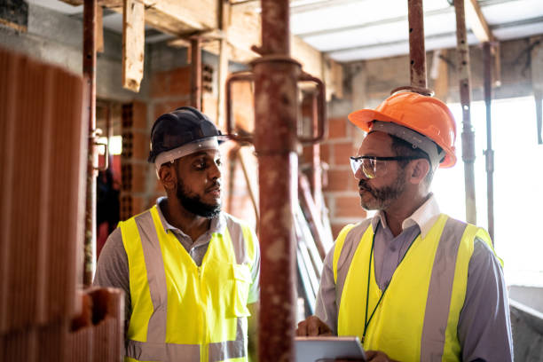 istock Engineer and contractor doing an informal meeting on construction site 1334832346