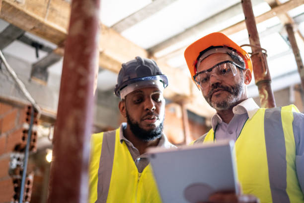 istock Engineer and contractor doing an informal meeting on construction site 1334832350