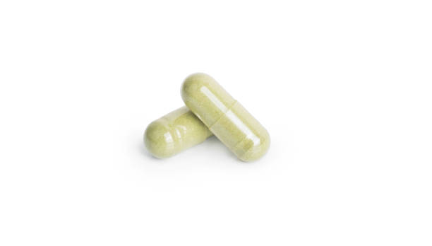 istock Andrographis paniculata pill capsule in green on white background with clipping path and copy space. Alternative medical from herb for treatment corona virus or covid19. Drug and medicine concept. 1334833661