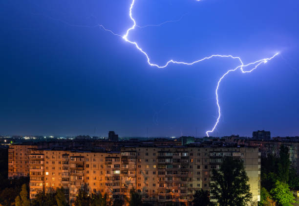 istock Thunderstorm with lightning above the night city 1334833683
