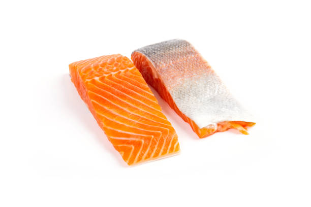istock Two small pieces of fresh trout on a white background 1334833889