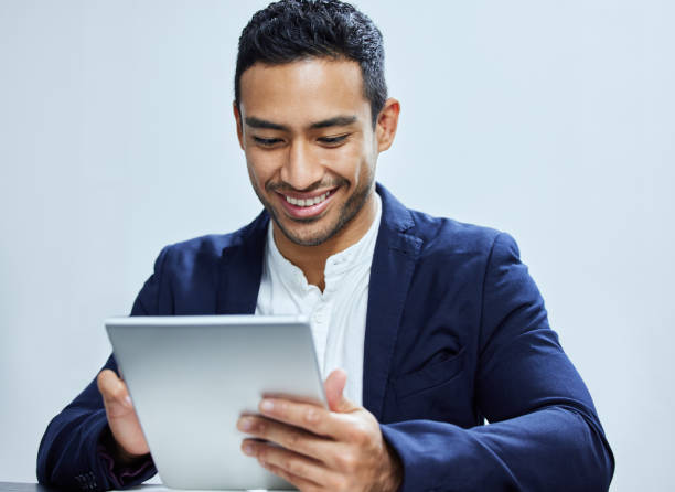istock Shot of a young  businessman using a digital tablet against a white background 1334838530