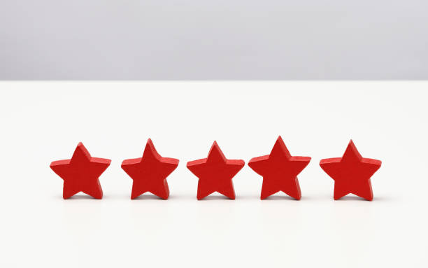 istock wooden five star shape on table. Best excellent business services rating customer experience concept, white table 1334839347