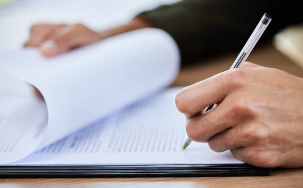 istock Closeup shot of an unrecognisable man going through paperwork 1334839439