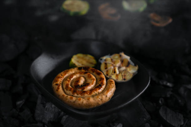 Charcoal grilled spiral sausages, courgettes and mushrooms