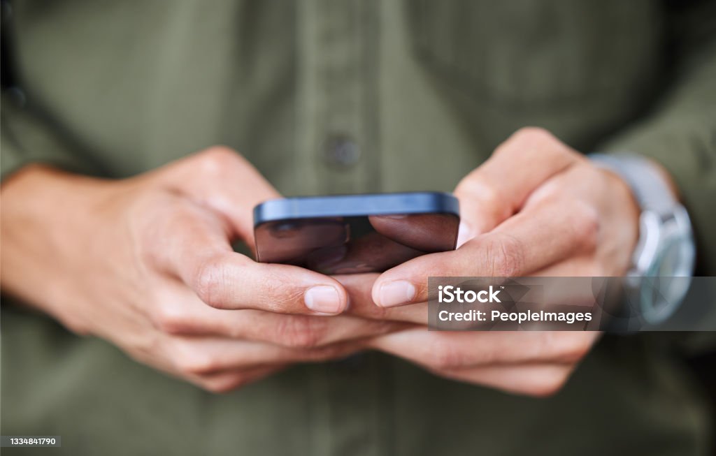 Closeup shot of an unrecognisable man using a cellphone Reading notifications as they pop up on his phone Notification Icon Stock Photo