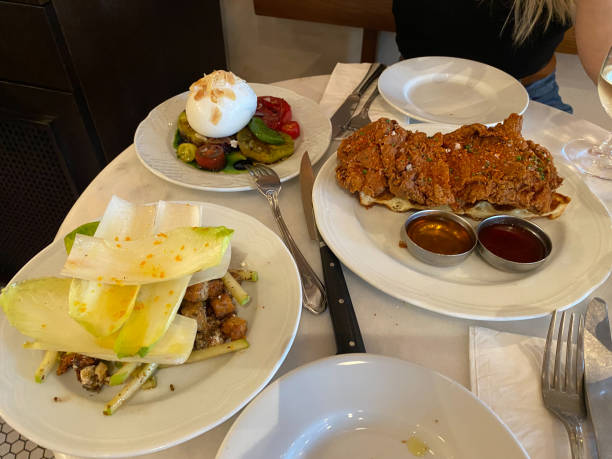 istock Crispy Chicken with Waffle, Lettuce Salad and Burrata Cheese served at Restaurant. 1334844514