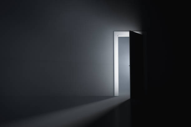istock A slightly open door in a dark room 1334844558