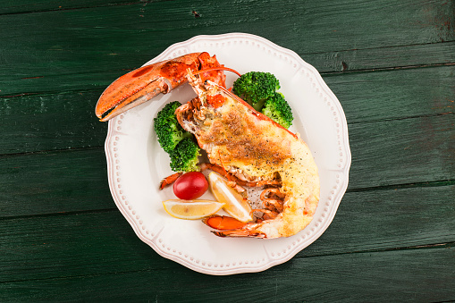 Lobster Thermidor, grilled lobster stuffed with cream and cheese, served with lemonBoston lobster with cheese