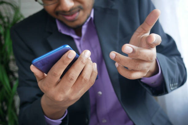 istock Close up of young man hand using smart phone. 1334848059
