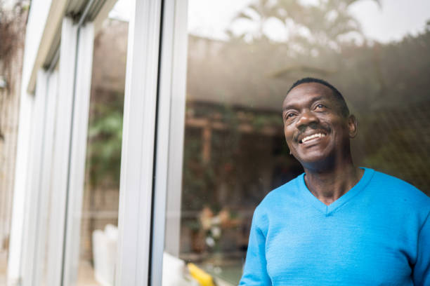 istock Happy senior man contemplating at home 1334849697