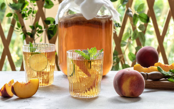 istock Homemade fermentation. Kombucha tea slightly alcoholic, lightly effervescent drink with peach and lime. 1334849724