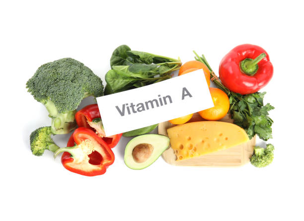 istock Different natural food and paper with text VITAMIN A on white background 1334851508