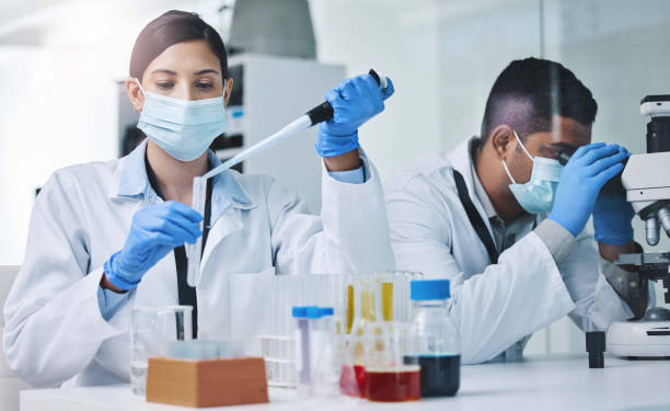 istock Shot of two young researchers working in a laboratory 1334851677
