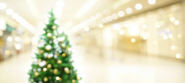 istock Beautiful decorated Christmas tree in light spacious shopping mall hall. 1334851921