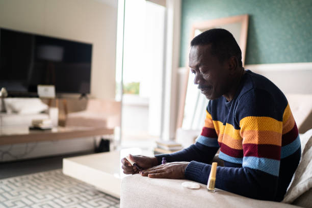 istock Senior man painting fingernails at home 1334852180