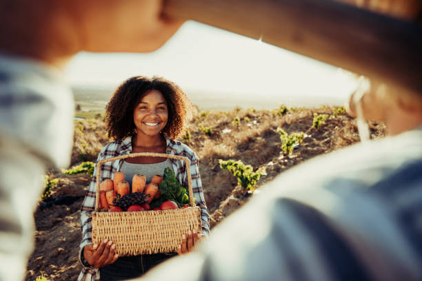 istock Smiling mixed race female farmer holding fresh vegetables 1334853340
