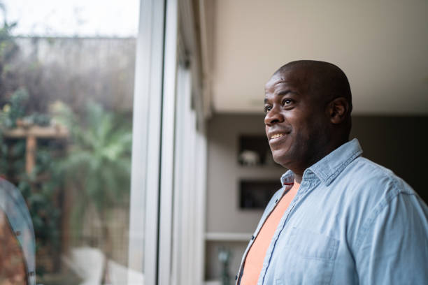 istock Men smiling and contemplating at home 1334854911
