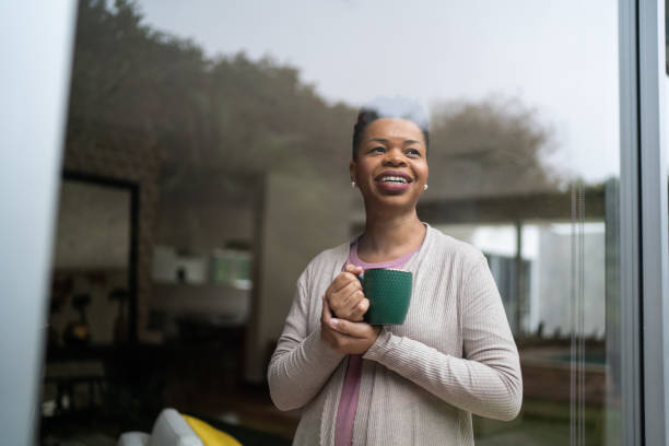 istock Woman contemplating holding a mug at home 1334854938