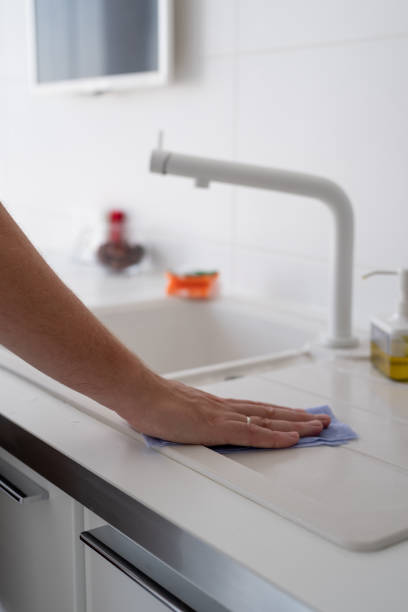 istock Man hand with rag cleaning the kitchen surfaces 1334856262