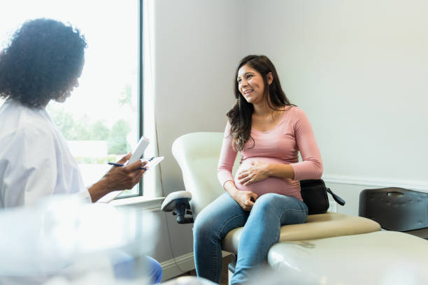 istock Doctor holds box of vitamins while talking with female patient 1334856814