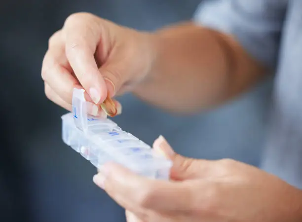 Photo of Cropped shot of a senior woman holding her weekly pill box