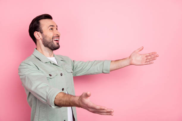 istock Profile side view portrait of attractive cheerful brunet guy catching wait copy space isolated over pink pastel color background 1334859496