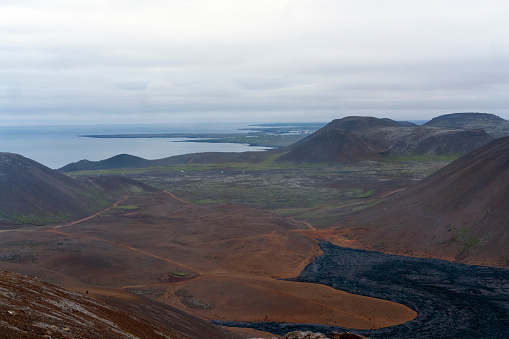 Top view of crust cooling lava from  Fagradalsfjall volcano vicinity after the eruption began three and half months ago on cloudy dark day.