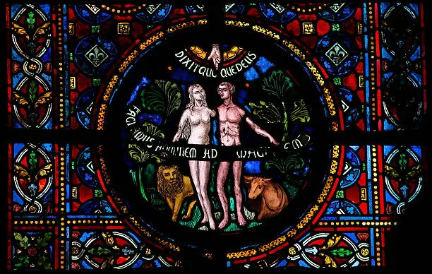 Creation of Adam and Eve, stained glass window in the church of Dinant, Belgium, created in 1821, no property release is required.