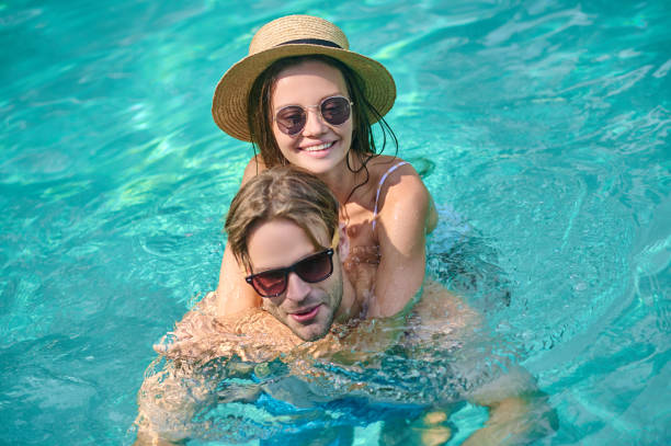 istock A young happy couple swimming in a pool 1334866136