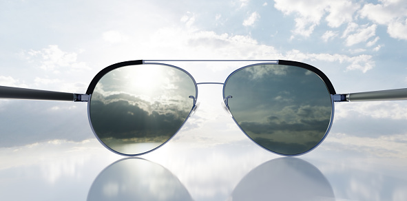 Polarized sunglasses on sunny sky. UV protection, polarization