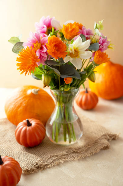 istock Autumn flowers and pumpkins, fall warm backdrop 1334866431