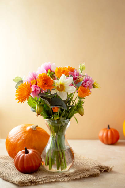 istock Autumn beautiful composition with flower bouquet in vase and pumpkins,fall warm backdrop 1334866435