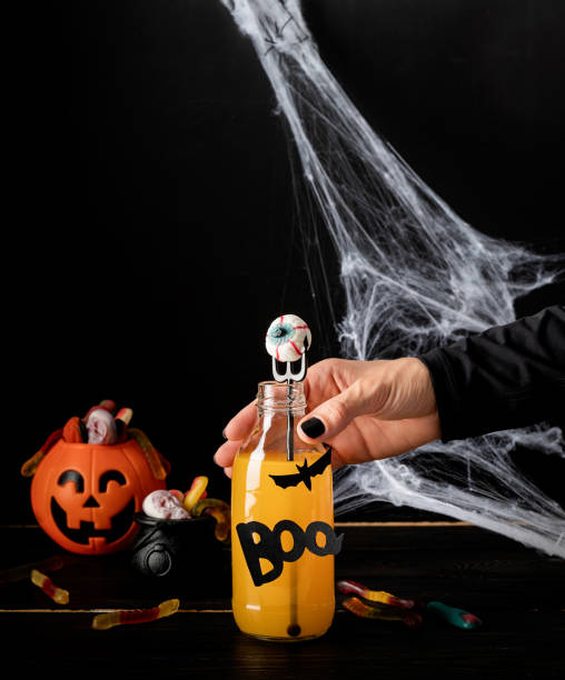 istock Scary colorful Halloween cocktail with party decorations on dark background with copy space 1334866928