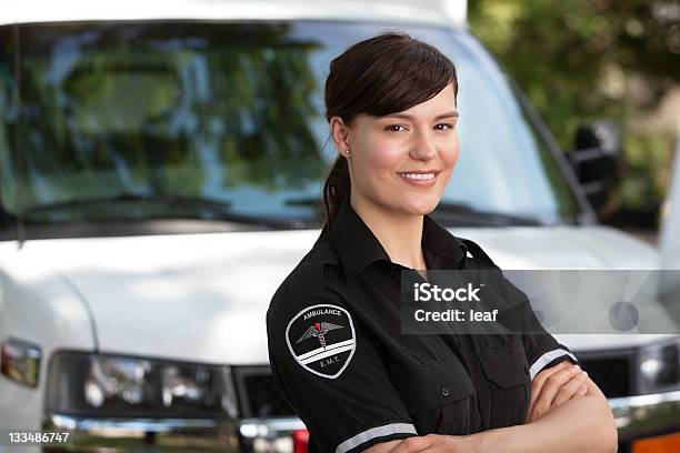 Female Paramedic Standing Outside Of Her Ambulance Stock Photo - Download Image Now - Paramedic, 2000-2009, 21st Century