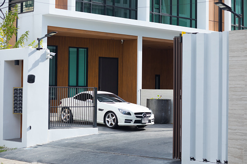 White Mercedes Coupe in front of modern luxury row house in residential district of Bangkok Ladprao near Ratchada Rd