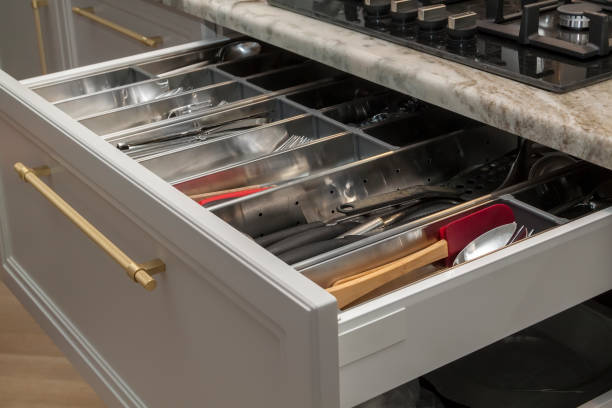 Close up view of opened modern kitchen drawer with cutlery stock photo