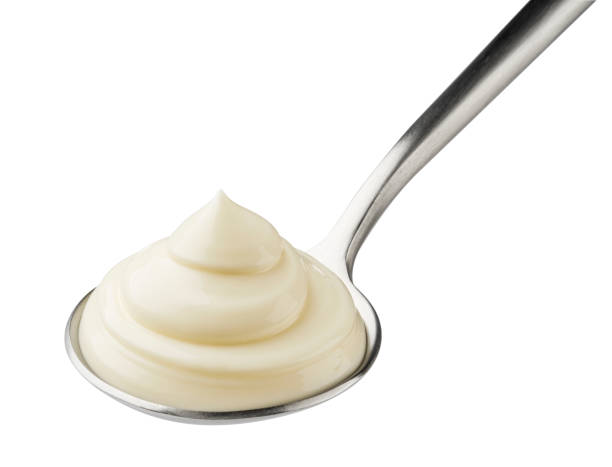 istock Mayonnaise in spoon isolated on white background 1334868444
