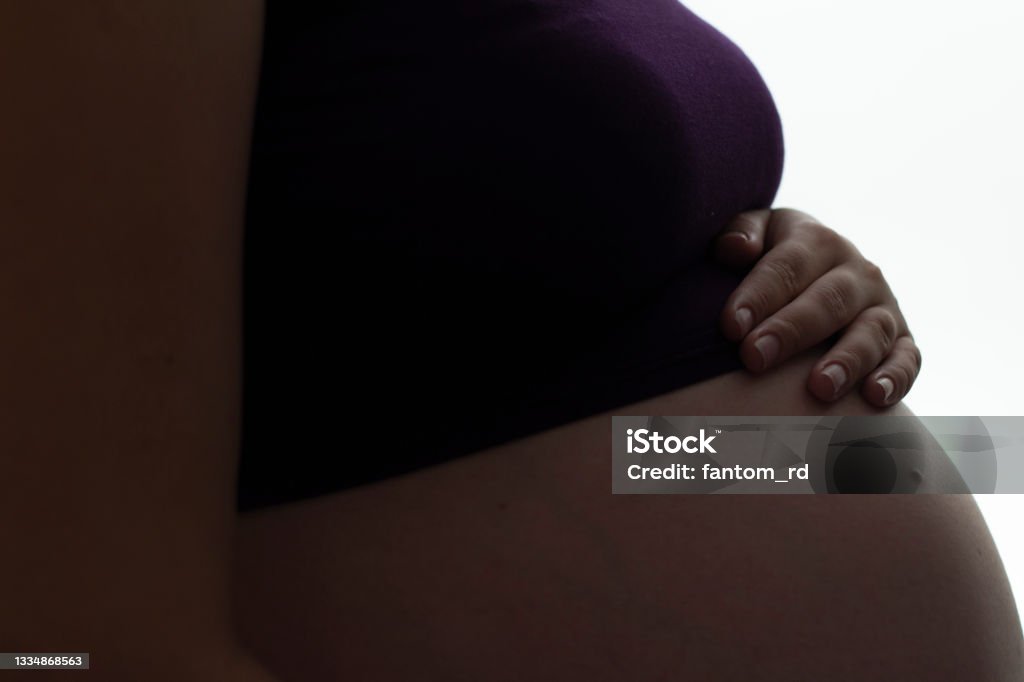 silhouette of pregnant woman's belly with hands touching it on white isolated background, new life concept silhouette of pregnant woman's belly with hands touching it on white isolated background, figure of female body in anticipation of baby, new life concept Pregnant Stock Photo
