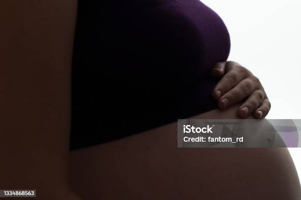 Silhouette Of Pregnant Womans Belly With Hands Touching It On White Isolated Background New Life Concept Stock Photo - Download Image Now