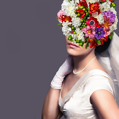 Bride with floral hairstyle. Woman with a bouquet on her head. Vogue style portrait.