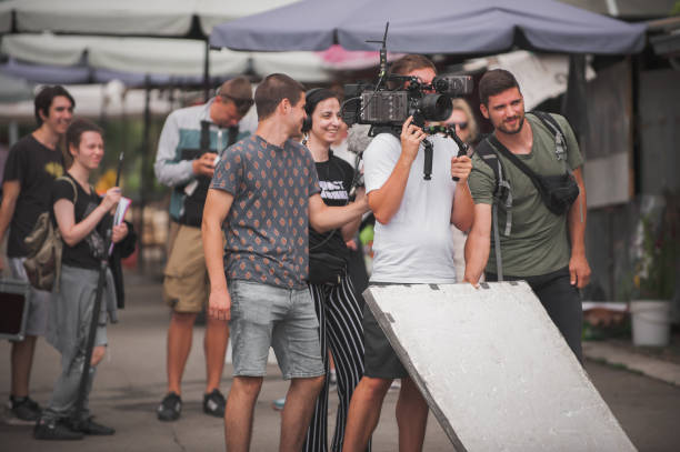 Behind scenes. Film crew team shooting movie scene. Group filmmaking Behind the scenes. Film crew team shooting movie scene on outdoor location. Group filmmaking set production reportage stock pictures, royalty-free photos & images