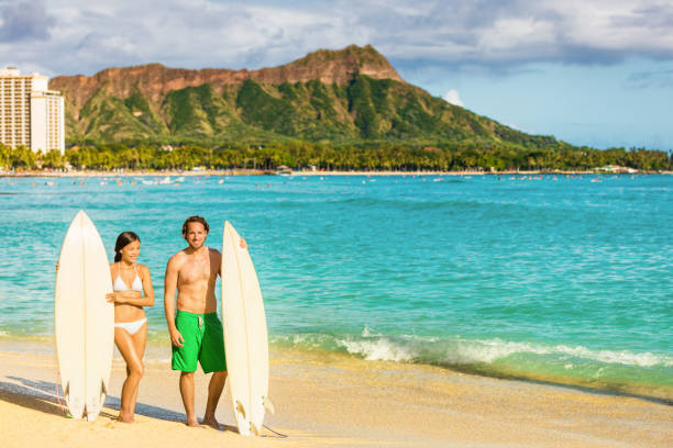 istock Hawaii surf couple on waikiki beach in Honolulu 1334871877