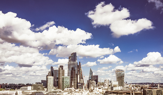 A high angle view over the towers of London's principal financial hub, the City of London, on a fresh and sunny day.