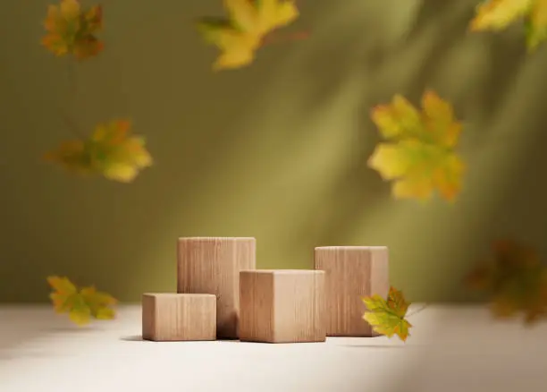 Photo of 3D background, wood podium display. Natural dry autumn leaf falling. Green backdrop with leaves shadow. Fall product promotion Beauty cosmetic, yellow wooden stand. Studio Minimal, template 3D render