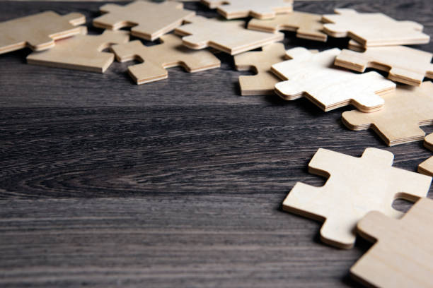 istock puzzle elements on a wooden background as a riddle closeup 1334878196