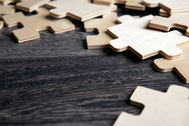 istock puzzle elements on a wooden background as a riddle closeup 1334878221