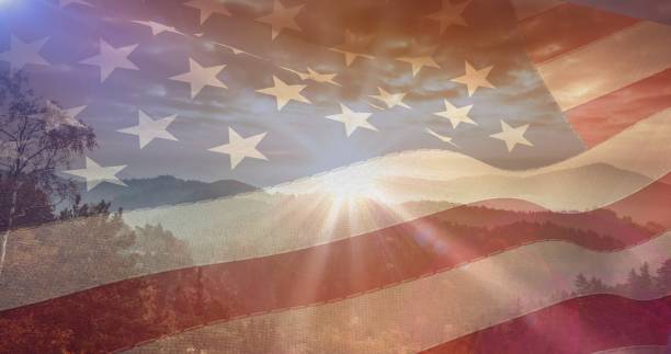 istock Composition of mountains, sky and sun over american flag 1334879317