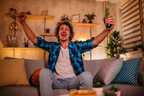 istock Man watching basketball on TV 1334881781